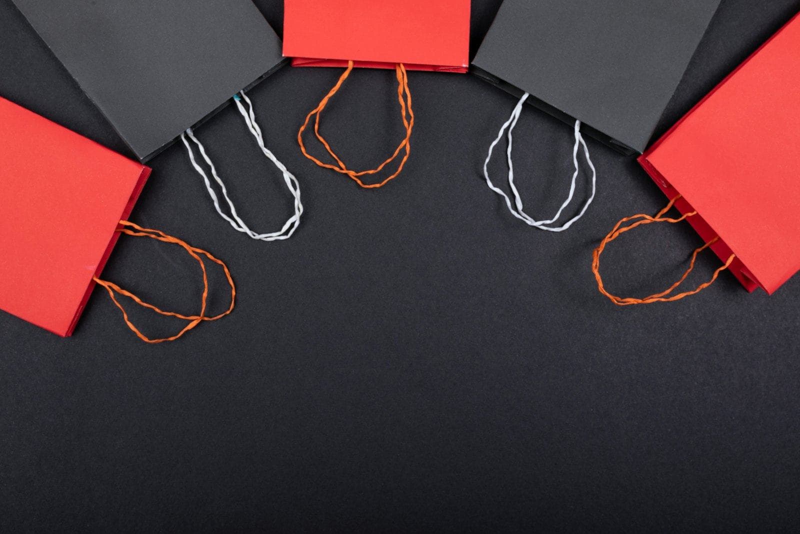 Red and black paper shopping bags laid out together