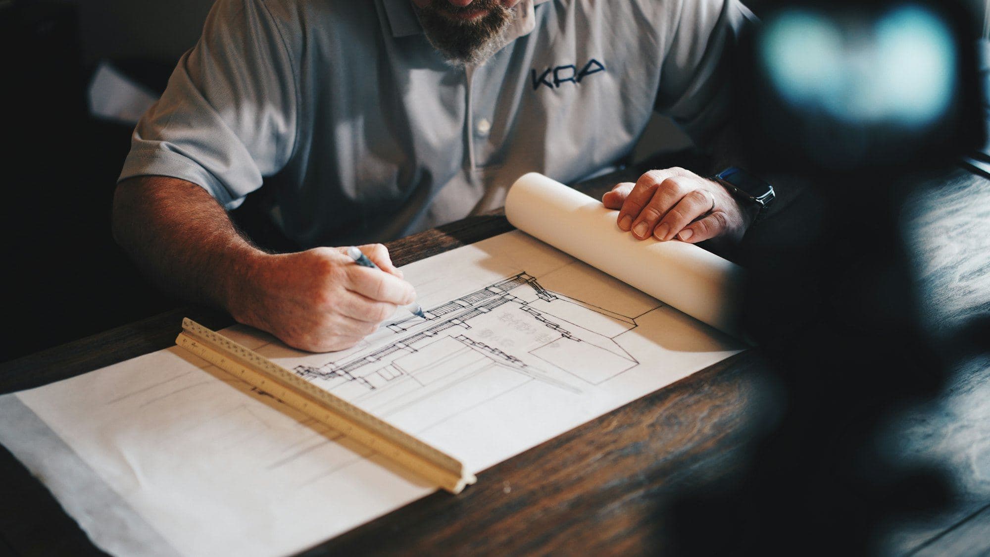 A hand drawing on a plan sheet with pencil and scale ruler